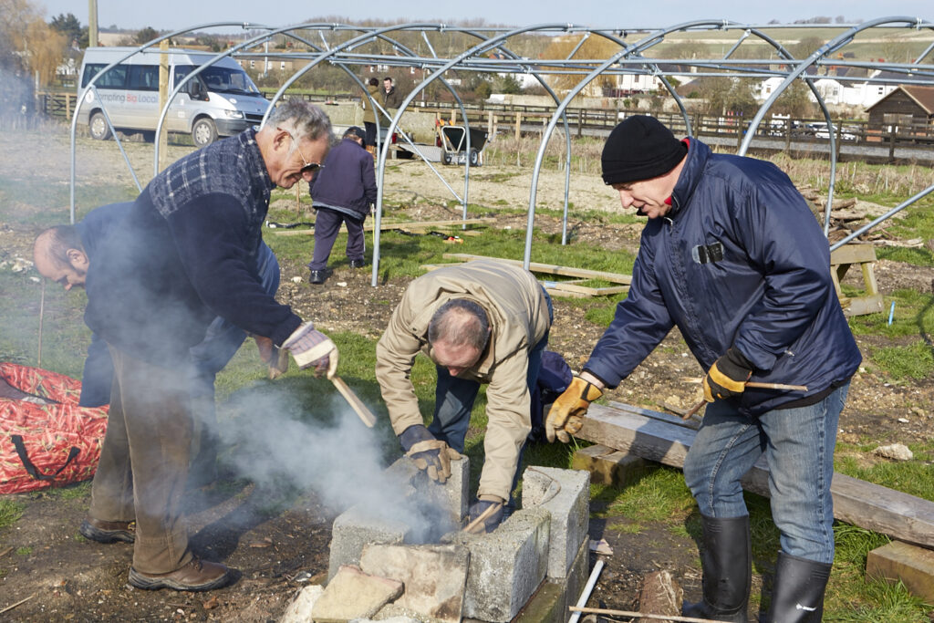 Men making a fire outdoors