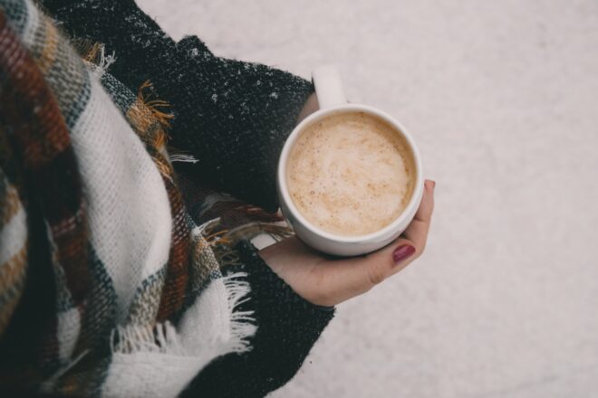 Close up of hands around a mug