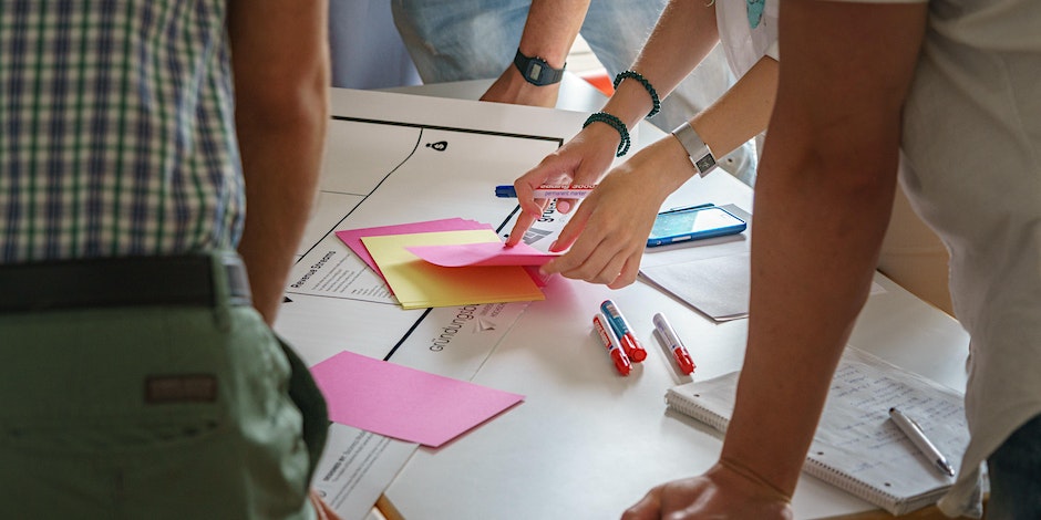 Close up of people looking at notes on a table