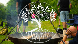 People gathered round a fire outdoors